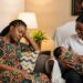 A new Nigerian mum rests while family helps care for her baby during omugwo