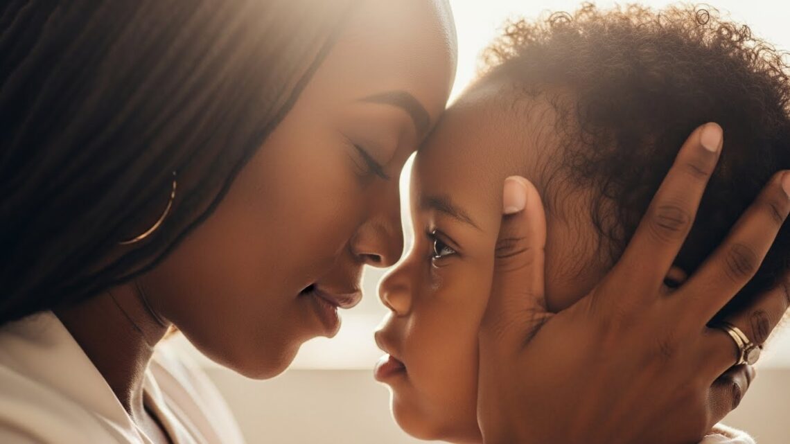 A mother gently holding her child’s face, both touching foreheads in a warm, reassuring moment.